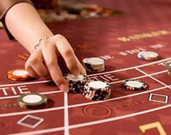 female hand placing chips on a baccarat table